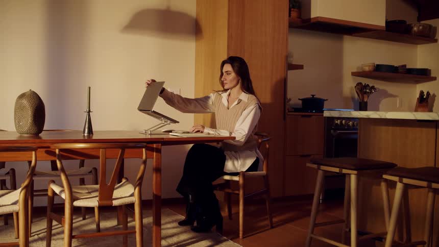 Woman opening her laptop on the table