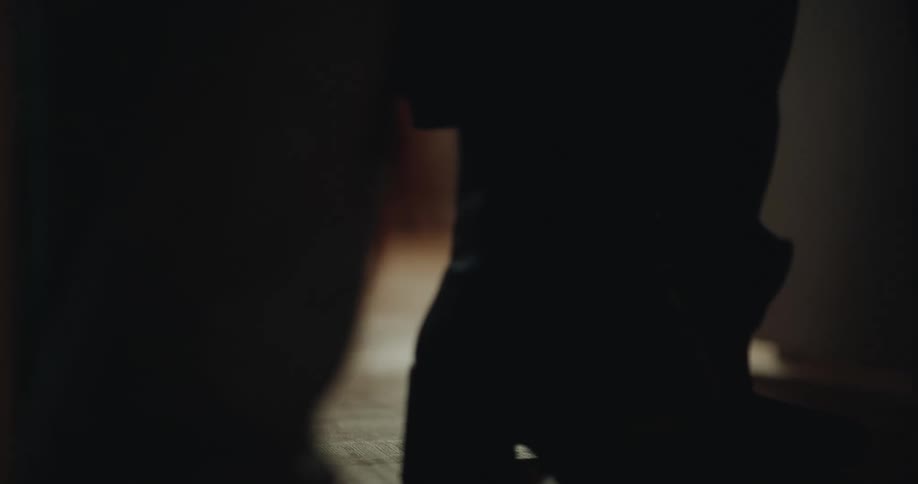 Two people walking down a hallway