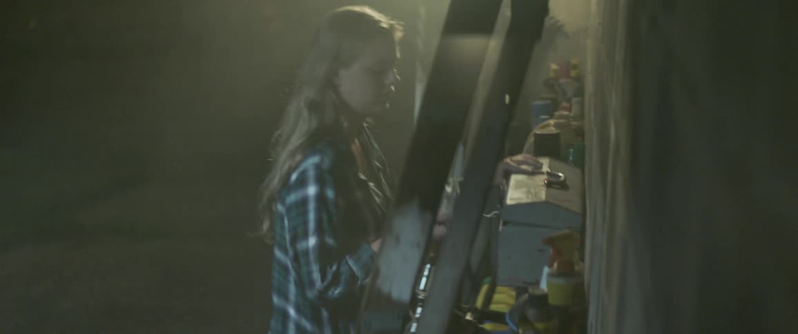 Woman takes something out of a metal box and walks away