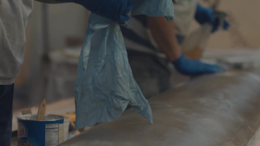 Workers are wiping the machine with rags