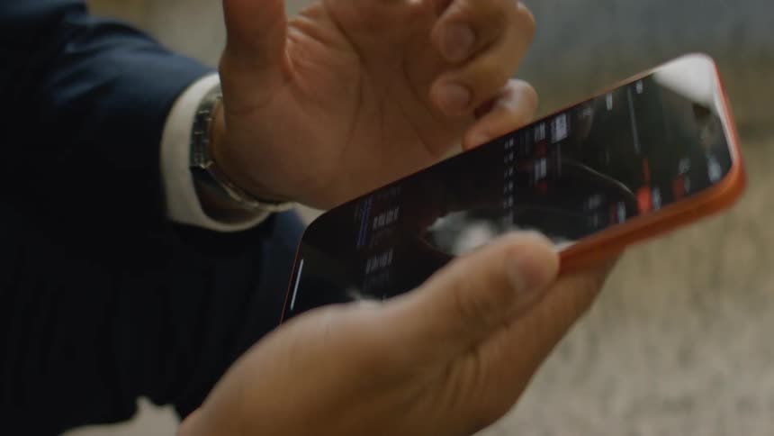 A mans hands are scrolling on a smartphone