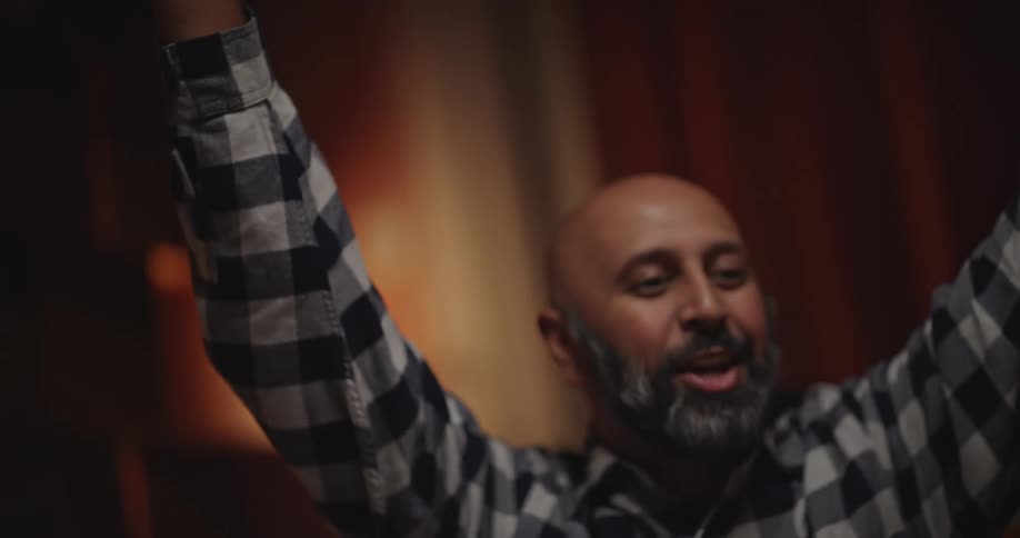 Man clapping hands with another person while interacting happily