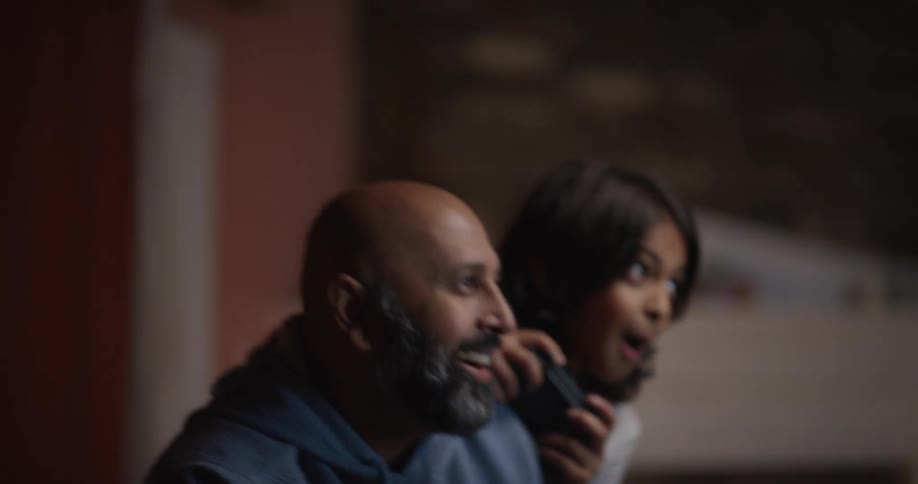 Man and a child having fun playing video games