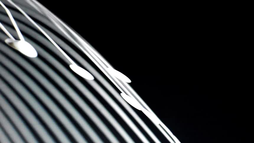 The lines appear as bright glowing white arcs that sweep across a dark background creating a sense of rapid motion and curvature as they rotate into view