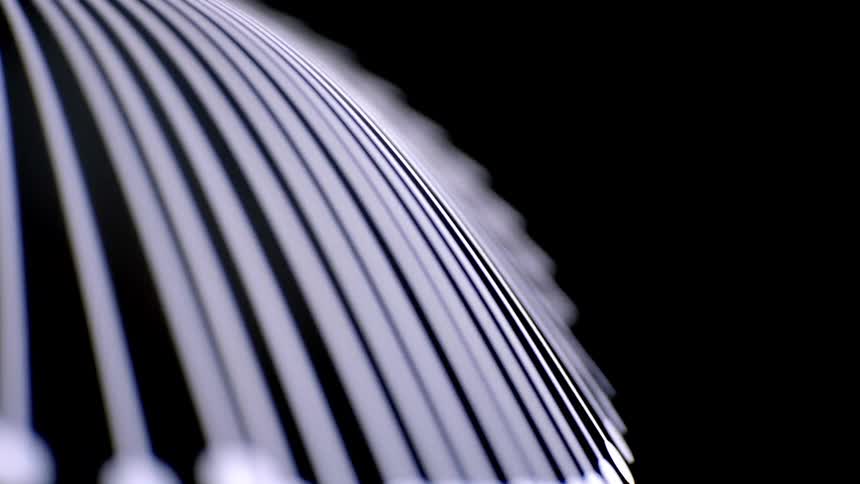 Closeup of glowing white curved lines with shallow depth of field against a black background