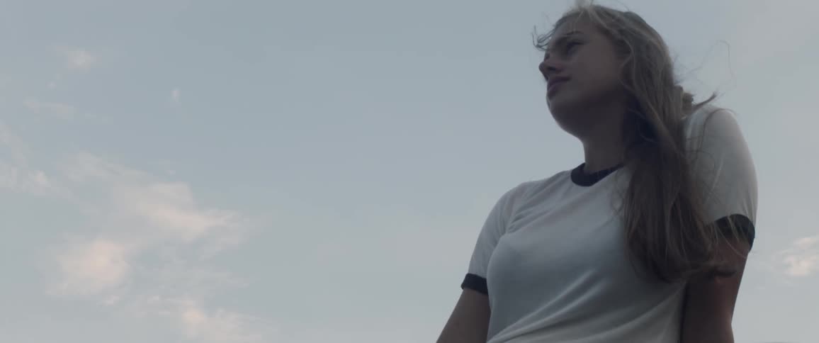 A woman sits outside and looks around