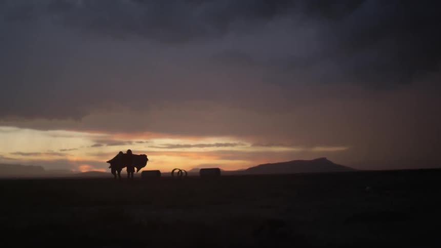 Two people dancing at sunset