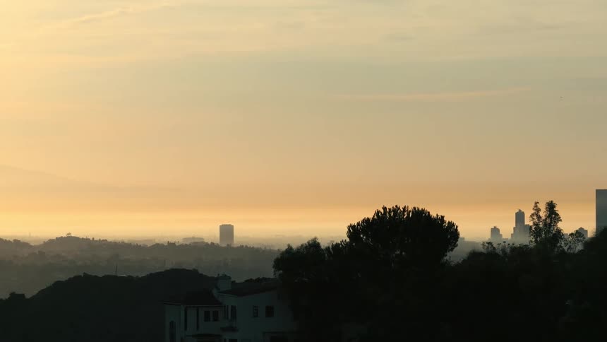 House on a mountain in the foreground and in the background the buildings of a metropolis