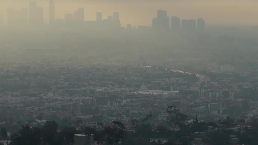 Metropolitan area covered in smog outdoors during dusk or dawn