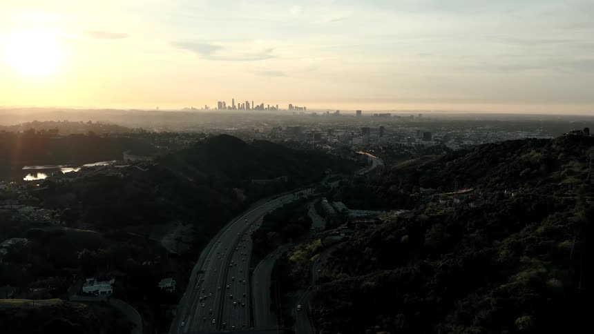 The freeway runs through the suburbs into the city in the distance