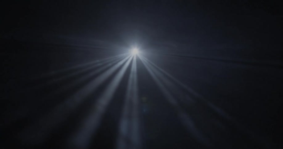 A bright light shining through complete darkness