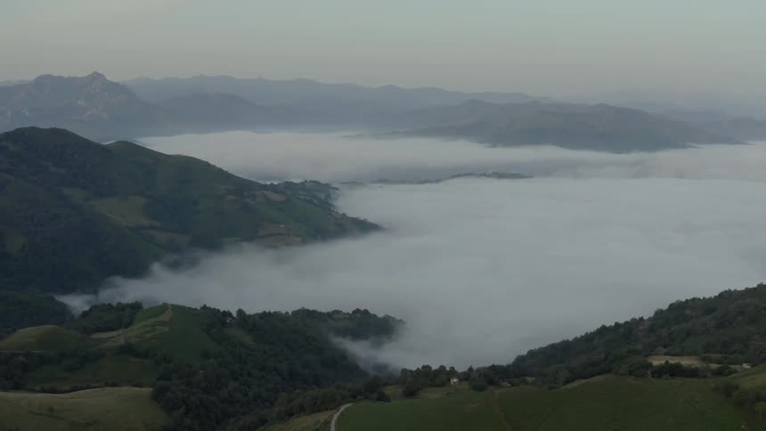 Natural landscape of mountains and valleys covered by mist outdoors during day time