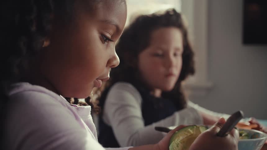 Two girls sitting eating