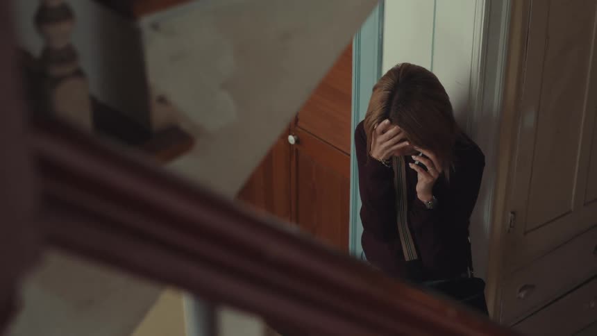 Woman crying while talking on the phone