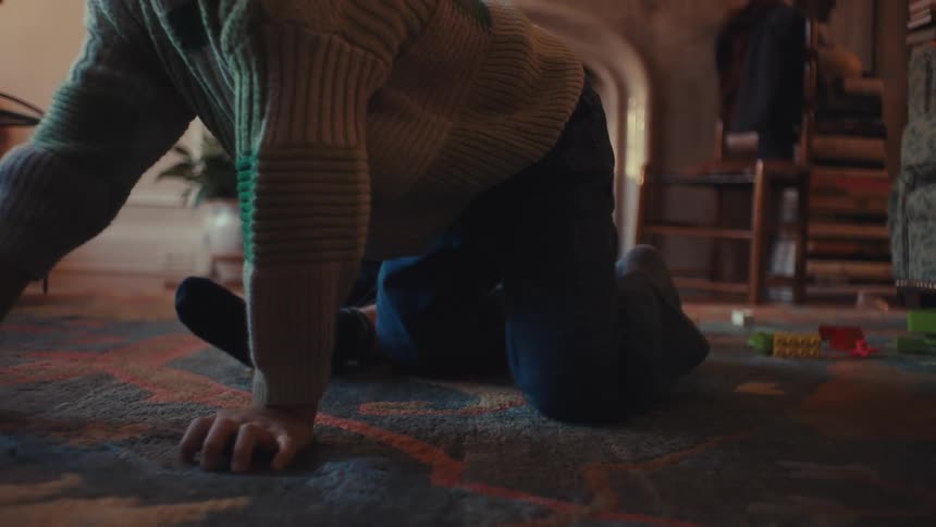 Two children fighting over a toy in the living room