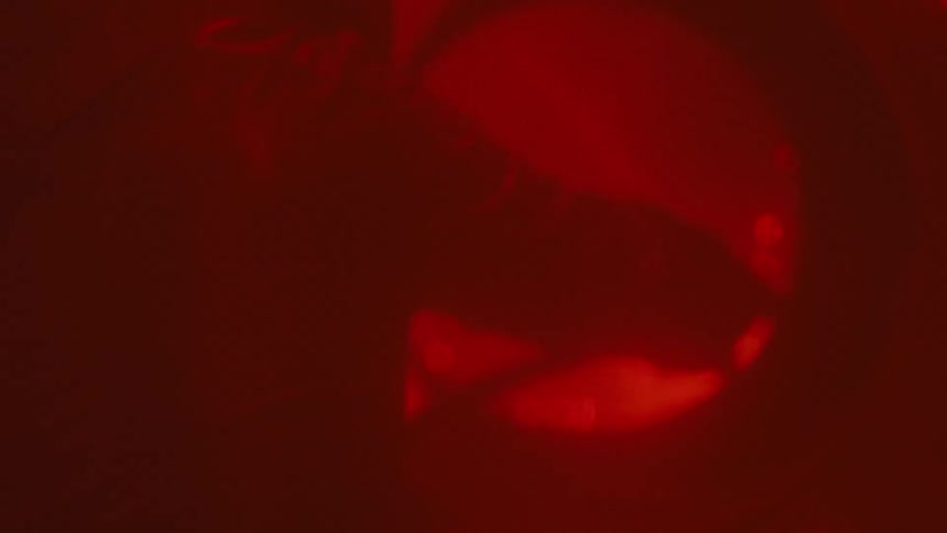 A person welds steel at a construction site sparks glowing brightly as they work