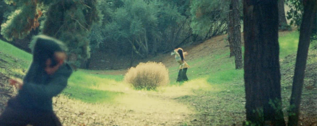 Two people dancing a choreography in a field