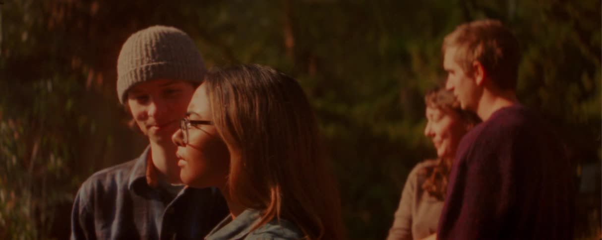 Adult people form couples in an outdoor setting with warm evening light