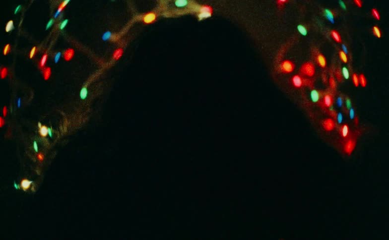 A portrait of a woman looking at christmas trees