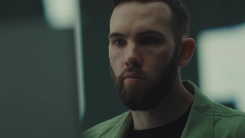 The man is looking at a computer screen