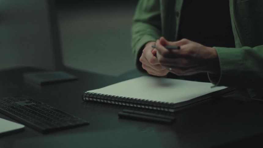 A man designing on a computer and paper