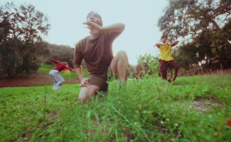 The woman is doing tai chi while kneeling