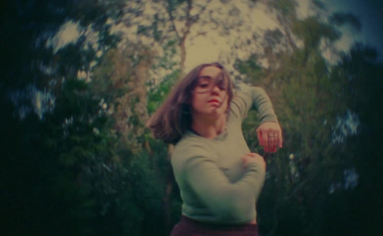 Close up of a young female dancer dancing outdoors during daytime
