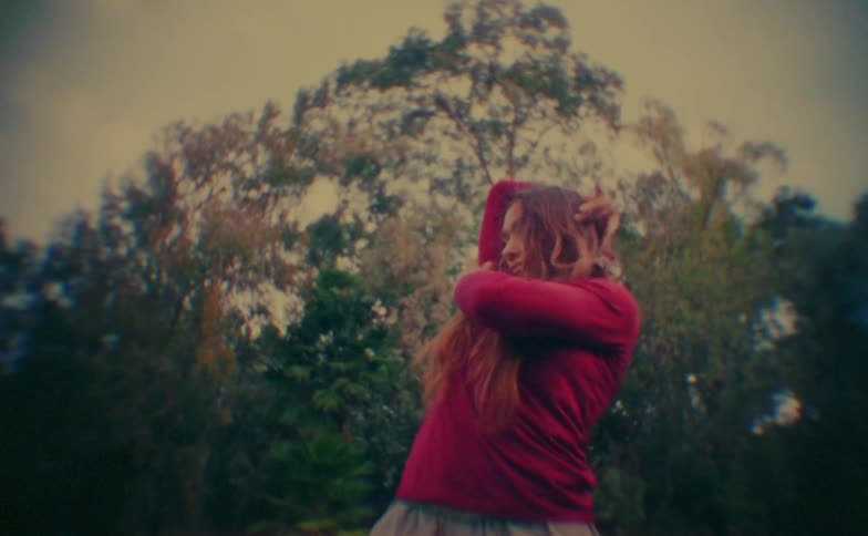 A young woman dancing outdoors during daytime