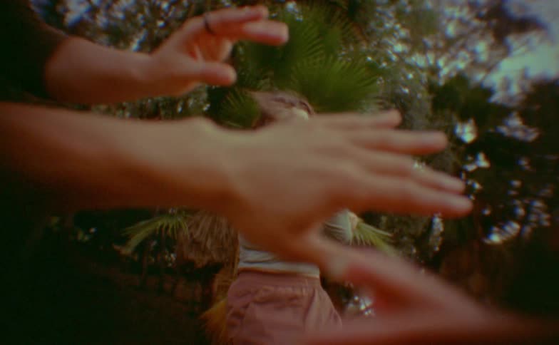 Woman dancing and hands emerging in the foreground