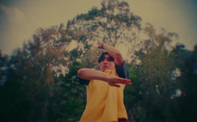 Young man break dances while outdoors on an autumn day