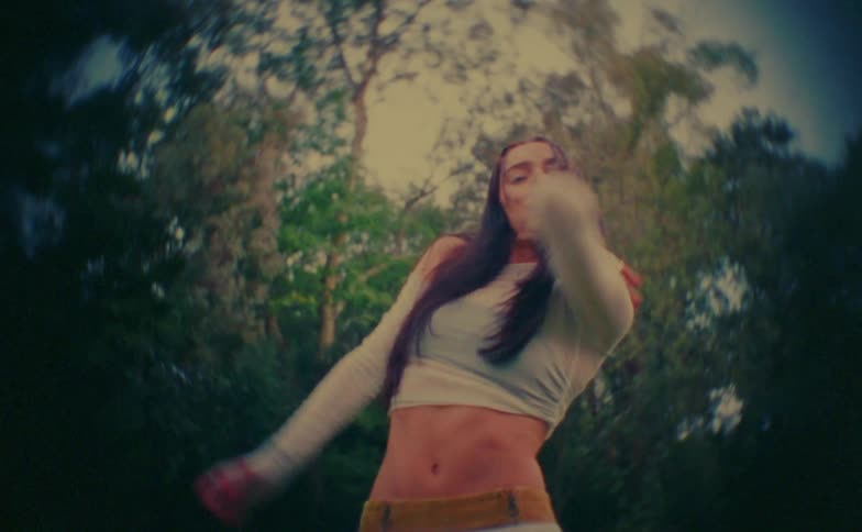 Woman dancing among trees