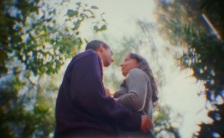 The couple are hugging and talking