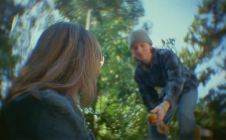 Man collecting and delivering fruit to a woman