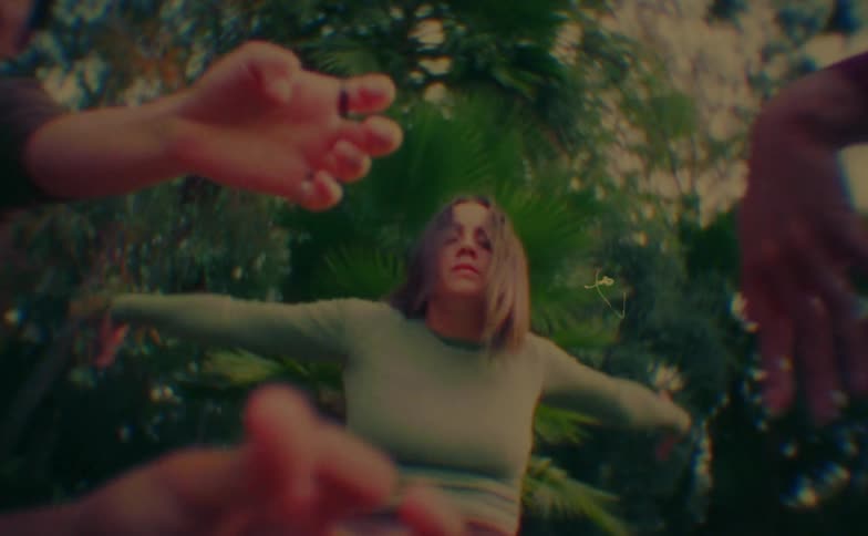 Woman dancing in a performance amidst trees
