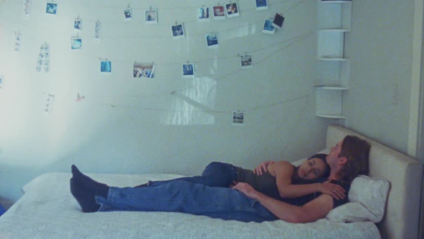 A young couple cuddling and kissing each other together outdoors and indoors during daytime