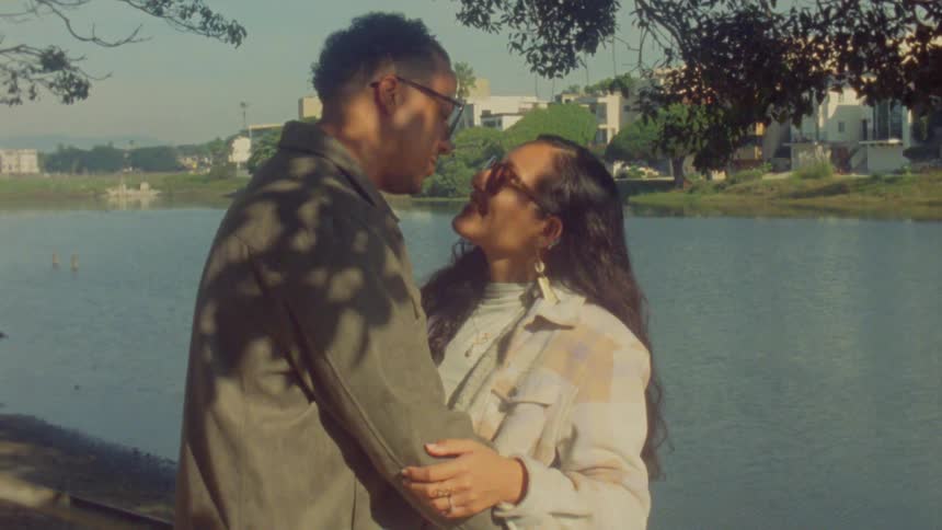 The couple are hugging by the canal