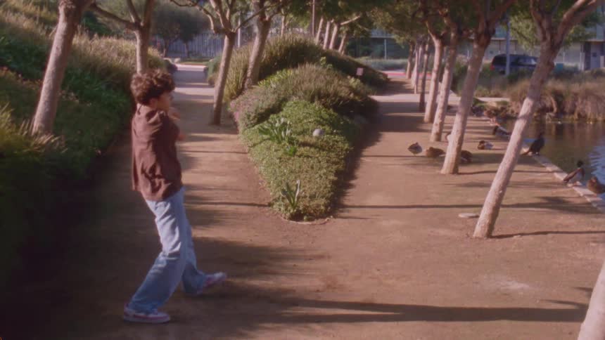 A man dancing outdoors on a sunny day