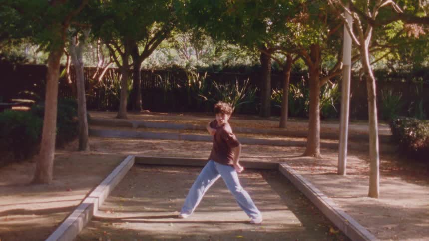 Boy in a backyard with dancing trees