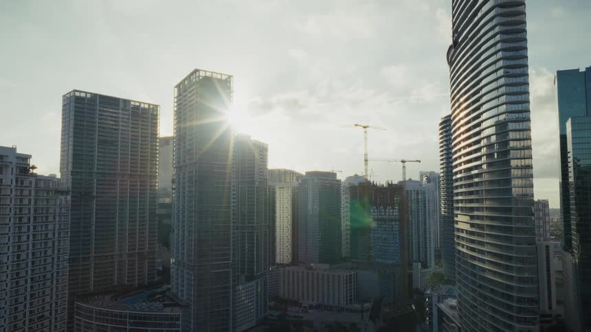 Sun flares behind buildings in Downtown Miami