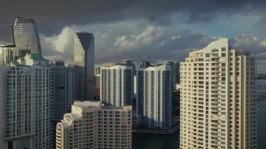 Approaching Downtown Miami by flying over skyscrapers and high rise towers along the waterfront of Florida