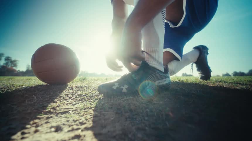 Soccer player tying his shoelaces