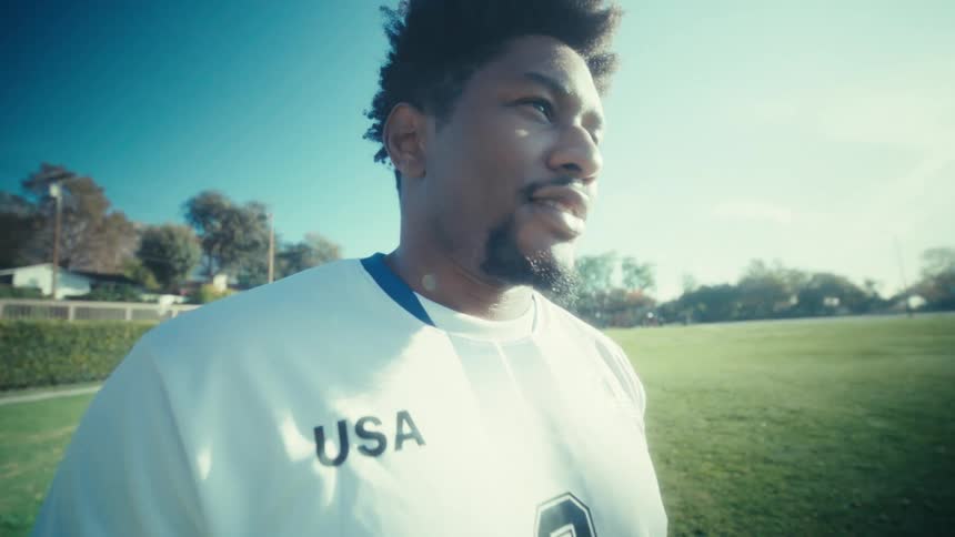 Man in a sports uniform on a grass field
