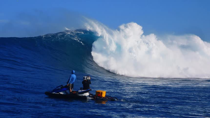 Filmmaker filming a big wave