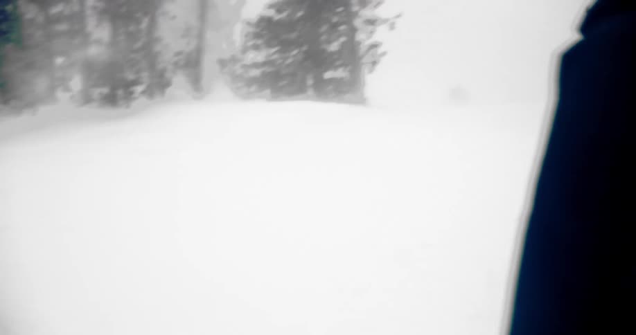 A group of skiers glides downhill on a snowy mountain slope during a winter day