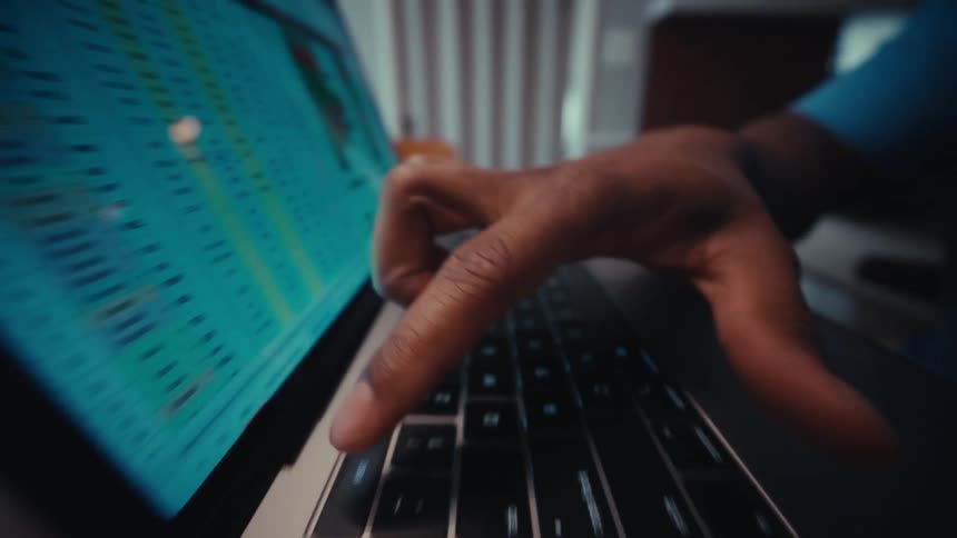 Person typing on a macbook