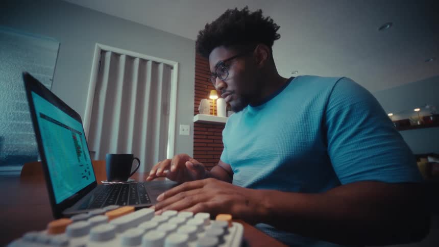 A man using a laptop in a room