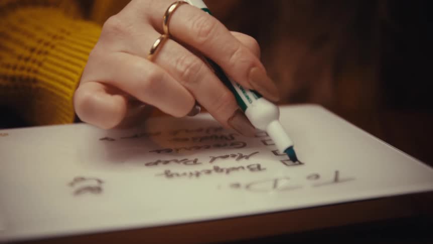 A woman writing on a whiteboard