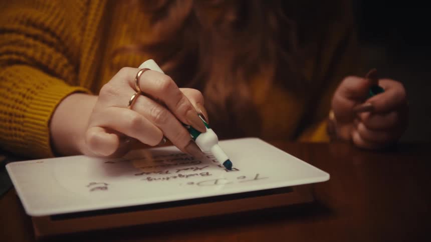 A woman writing on a whiteboard