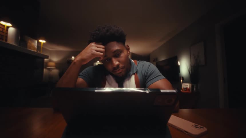A man using a laptop in a room