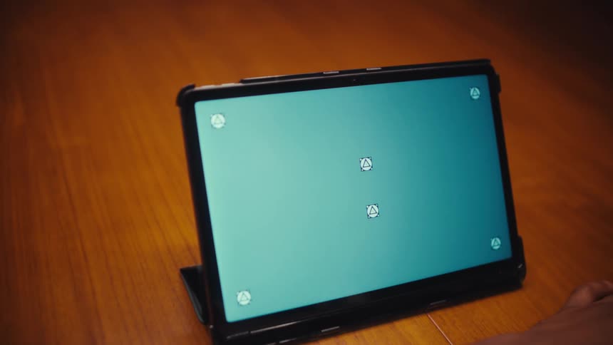 A man looking at a computer tablet